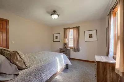 a bedroom with a bed and a window at Wyandot Woods - Hillside in Laurelville
