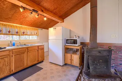 a kitchen with a white refrigerator and a stove at Wyandot Woods - Squirrels Nest in Laurelville