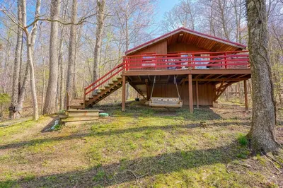 a large house with a deck in the woods at Wyandot Woods - Squirrels Nest in Laurelville