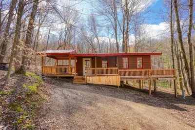 a cabin in the woods with a dirt road at Wyandot Woods - Firefly in Laurelville
