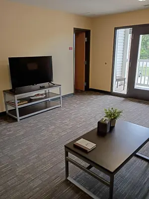 a living room with a tv and a coffee table at Spacious and Modern Stay to Relax & Recharge in Mansfield