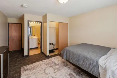 a bedroom with a bed and a bathroom at Spacious and Modern Stay to Relax & Recharge in Mansfield