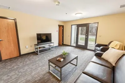 a living room with a couch and a tv at Bright and Connected Your Ideal Getaway in Mansfield