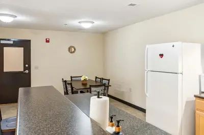 a kitchen with a white refrigerator and a table at Bright and Connected Your Ideal Getaway in Mansfield
