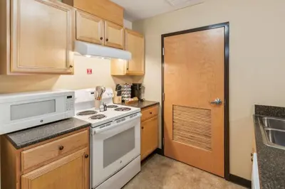 a kitchen with a white stove top oven next to a door at Bright and Connected Your Ideal Getaway in Mansfield