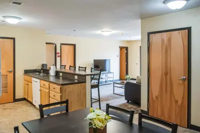 an open kitchen and dining room with tables and chairs at Bright and Connected Your Ideal Getaway in Mansfield