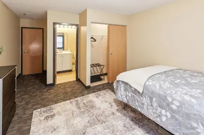 a hotel room with a bed and a bathroom at Bright and Connected Your Ideal Getaway in Mansfield