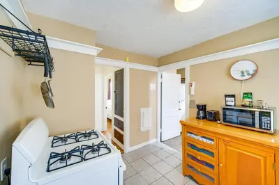 a kitchen with a stove and a microwave at Home 2 Mi to Lakewood Park and Solstice Steps! in Lakewood