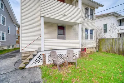 a house with a bench in front of a house at Home 2 Mi to Lakewood Park and Solstice Steps! in Lakewood