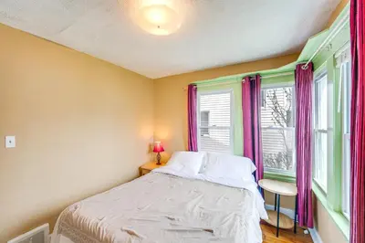 a bedroom with a bed and a window at Home 2 Mi to Lakewood Park and Solstice Steps! in Lakewood