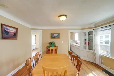 a dining room with a wooden table and chairs at Home 2 Mi to Lakewood Park and Solstice Steps! in Lakewood