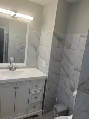 a bathroom with a sink and a mirror at Liberty Twp Spacious 4 bedroom house in Middletown