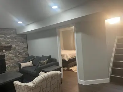 a living room with a couch and a chair at Liberty Twp Spacious 4 bedroom house in Middletown