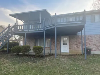 a house with a staircase on the side of it at Liberty Twp Spacious 4 bedroom house in Middletown