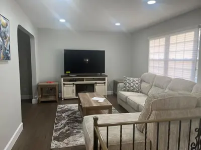 a living room with a couch and a flat screen tv at Liberty Twp Spacious 4 bedroom house in Middletown