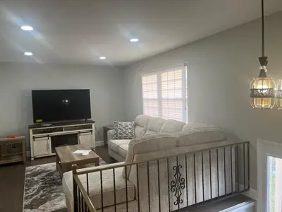 a living room with a couch and a tv at Liberty Twp Spacious 4 bedroom house in Middletown
