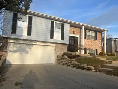 a brick house with a garage in front of it at Liberty Twp Spacious 4 bedroom house in Middletown