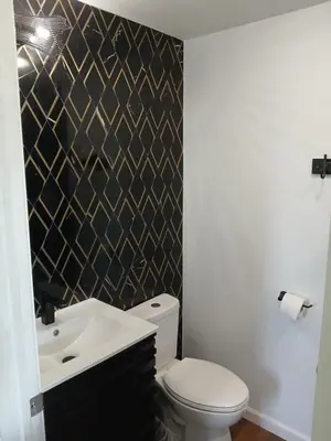 a bathroom with a white toilet and a sink at Branson House Bed & Breakfast in Marion