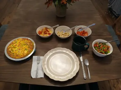 a table with plates and bowls of food on it at Branson House Bed & Breakfast in Marion