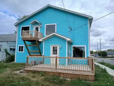 a blue house with a wooden fence in front of it at Branson House Bed & Breakfast in Marion