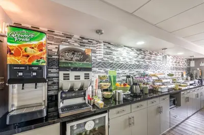a restaurant kitchen with a counter with food on it at Quality Inn Grove City - Columbus South in Grove City