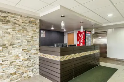 a cashier counter in a fast food restaurant with a brick wall at Quality Inn Grove City - Columbus South in Grove City