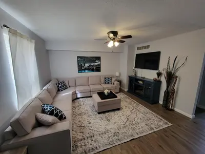 a living room with a couch and a flat screen tv at The Third Monkey in Williamstown