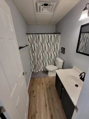 a bathroom with a white sink and a toilet at The Third Monkey in Williamstown