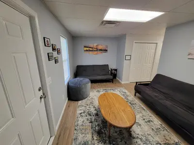 a living room with a couch and a table at The Third Monkey in Williamstown