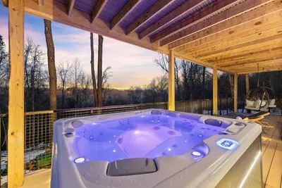a jacuzzi tub on the deck of a house at Adamina Canyon Luxurious, Canyon View 5BR,3BTH in Rockbridge