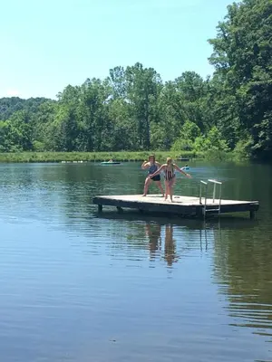 two people sitting on a dock in a lake at Trillium Ridge, Hocking Hills Area, 2 Bedroom, 3 Beds in Rockbridge