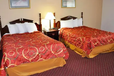 a hotel room with two beds with red covers at Avalon Inn in Sandusky