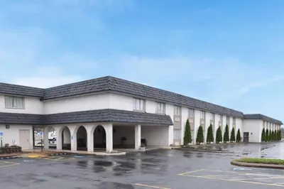 a building with a parking lot in front of it at Avalon Inn in Sandusky