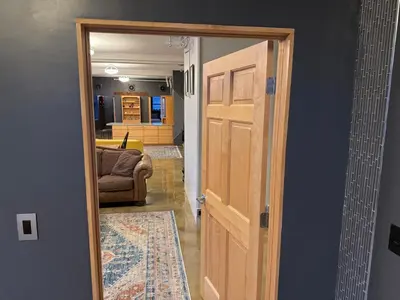 a door leading into a living room with a couch at Lee Flat in Charleston
