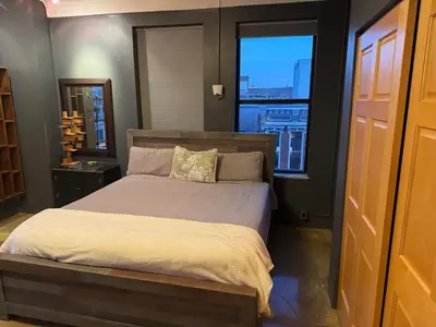 a bedroom with a large bed and a window at Lee Flat in Charleston