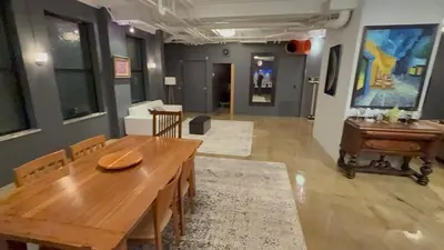 a dining room with a wooden table and a piano at Lee Flat in Charleston