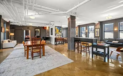 a living room with a table and chairs and a couch at Lee Flat in Charleston