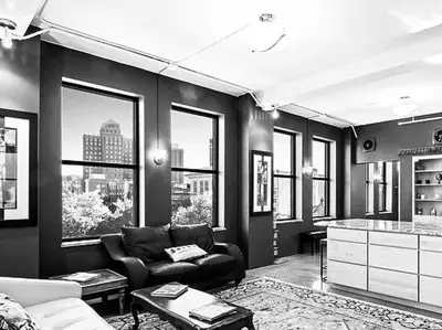 a living room with a couch and some windows at Lee Flat in Charleston