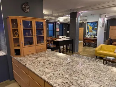 a kitchen with a counter top and a living room at Lee Flat in Charleston