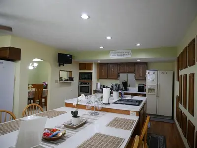 a kitchen with wooden cabinets and white appliances at PineRidge Country Retreat with In ground Pool and Hot Tub in Langsville
