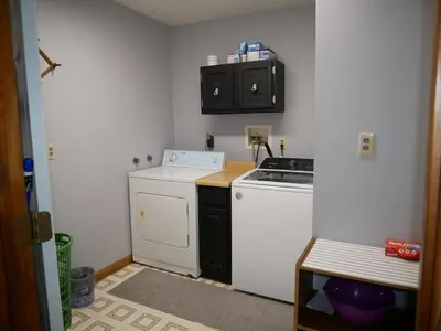 a small kitchen with a stove and a white dishwasher at PineRidge Country Retreat with In ground Pool and Hot Tub in Langsville