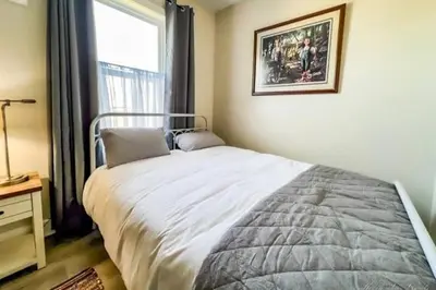 a bedroom with a large bed and a window at Coastal Retreat in Sandusky