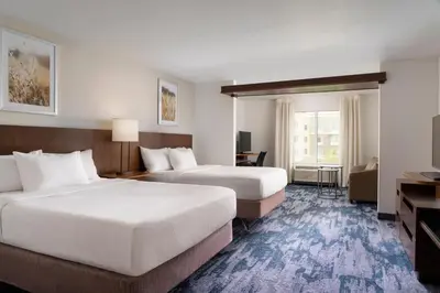 a hotel room with two beds and a desk at Fairfield Inn & Suites by Marriott Akron Fairlawn in Montrose