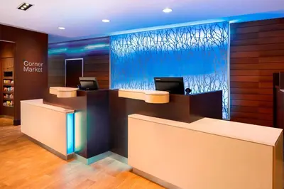 an office with a reception desk with a glass wall at Fairfield Inn & Suites by Marriott Akron Fairlawn in Montrose