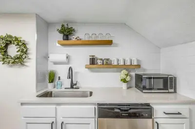 a kitchen with a sink and a microwave at New Renovated 1BR with King Modern Comfort in Berea