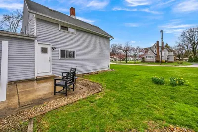 a house with a bench in front of a yard at New Renovated 1BR with King Modern Comfort in Berea