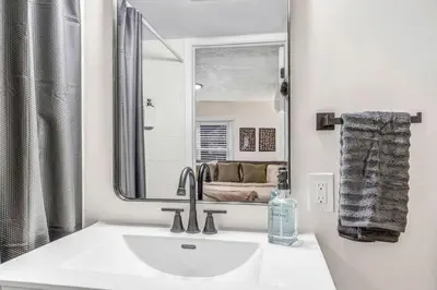 a bathroom with a sink and a mirror at New Renovated 1BR with King Modern Comfort in Berea