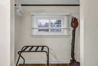 a window in a room with a chair and a vacuum at New Renovated 1BR with King Modern Comfort in Berea
