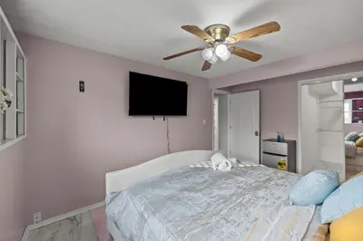 a bedroom with a bed and a ceiling fan at Cosy house, home away from home in Grove City