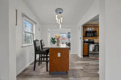 a kitchen and dining room with a table and chairs at Cosy house, home away from home in Grove City